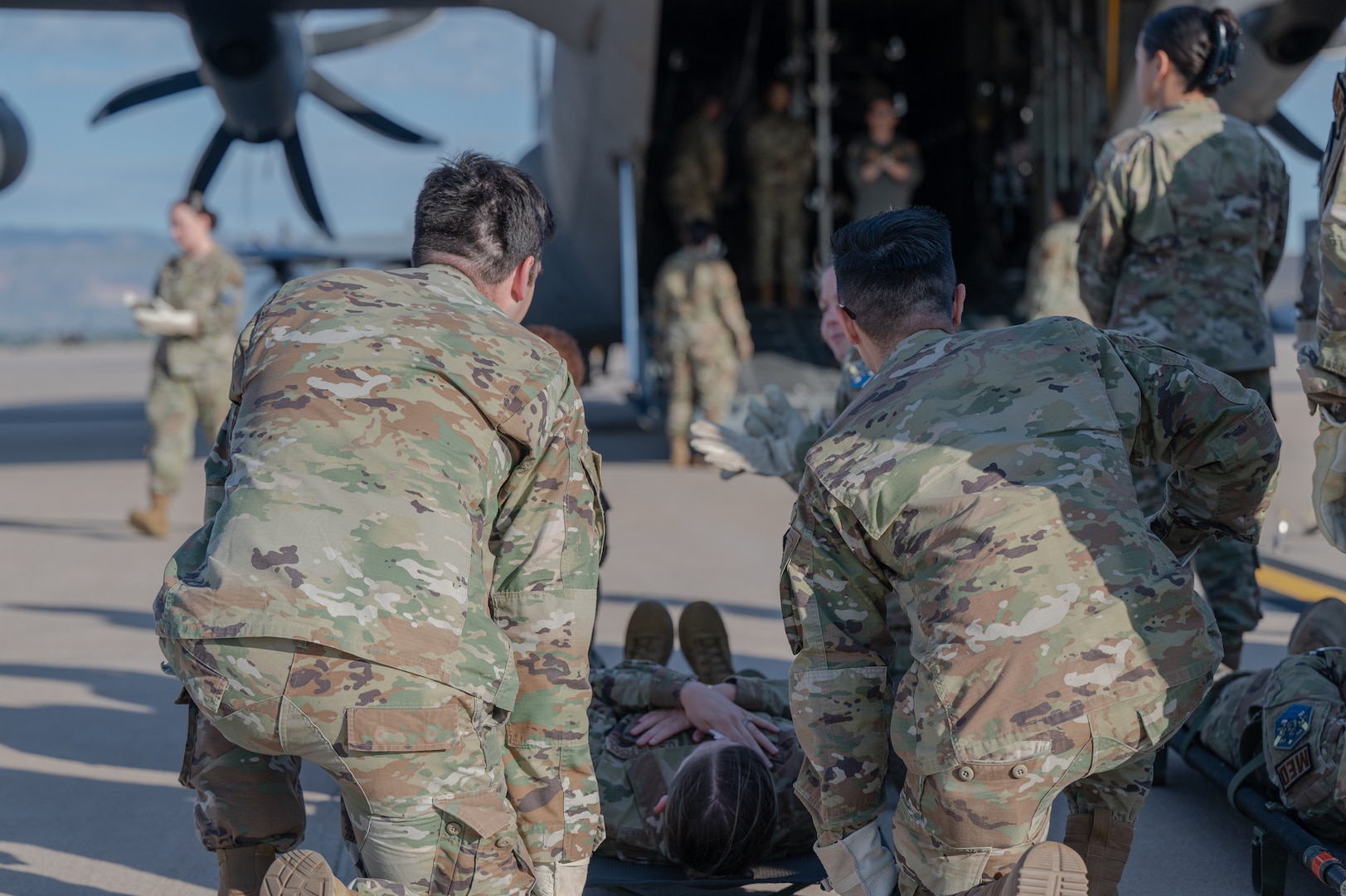 Members from the 21st Medical Group wait to bring their patient on-board a C-130 Hercules at Peterson Space Force Base, Colorado, Sept. 4, 2024. The 21st MDG and the 21st Security Forces Squadron partnered with the 302nd Airlift Wing to practice deployed medical skills. (U.S. Space Force photo by 2nd Lt. Jacob Willoughby)