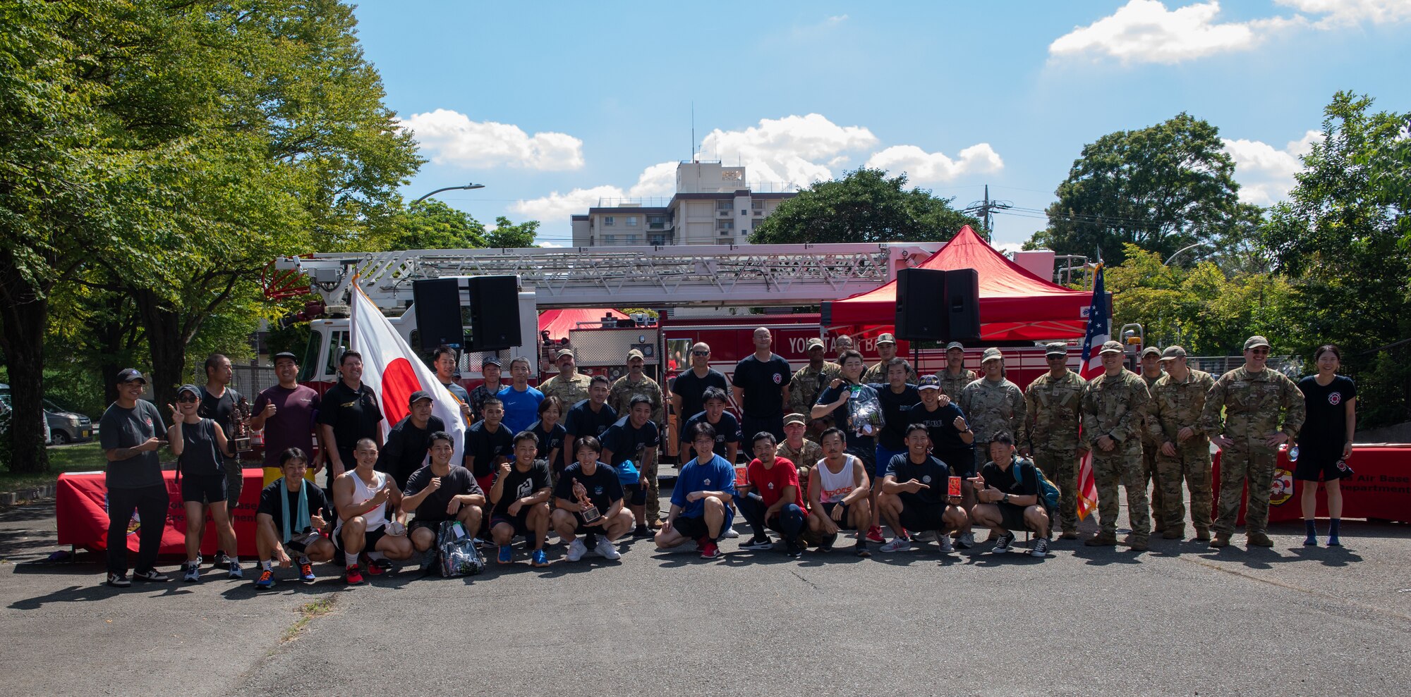 Participants of the 9/11 Memorial Tower Run pose for a photo in front of a fire engine