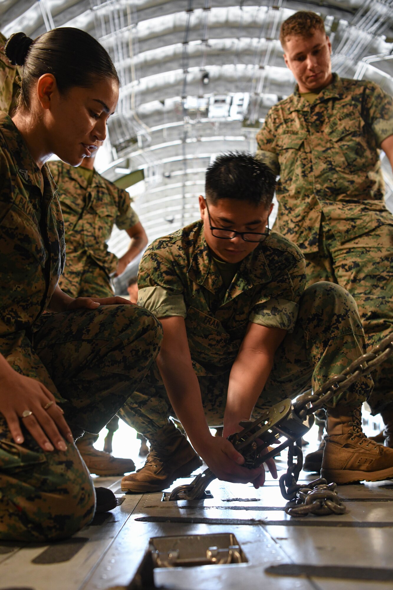 A marine conducts loading operations on a U.S. Air Force C-17 Globemaster III.