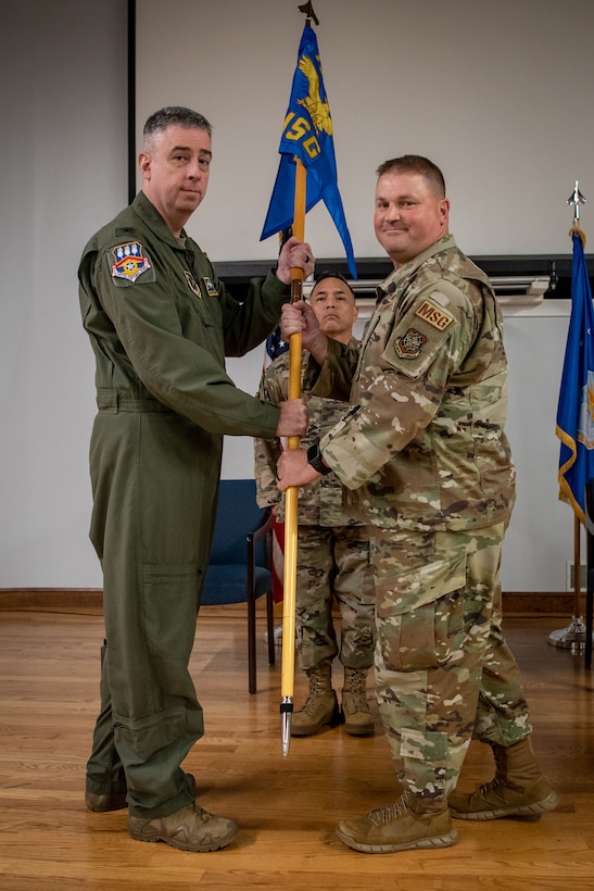 Lt. Col. Kevin Krauss, right, assumes command of the 123rd Mission Support Group as he accepts the unit guidon from Col. Bruce Bancroft, commander of the 123rd Airlift Wing, during a ceremony at the Kentucky Air National Guard Base in Louisville, Ky., July 21, 2024. Krauss replaces Col. Shawn Keller, who has been named to a post at the Defense Finance and Accounting Service. (U.S. Air National Guard photo by Master Sgt. Joshua Horton)