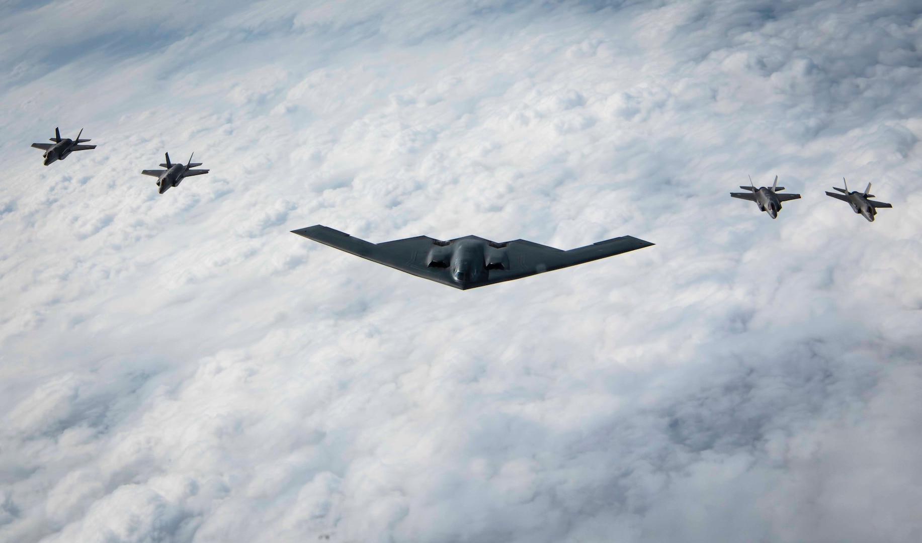 A U.S. Air Force B-2 Spirit stealth bomber and four Japan Air Self-Defense Force F-35A Lightning IIs, fly in formation over the Indo-Pacific area of responsibility, Sept. 10, 2024. Bomber missions provide opportunities to train and work with our Allies and partners in joint and coalition operations and exercises. (U.S. Air Force photo by Senior Airman Samantha White)