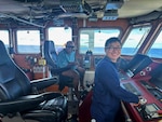 Ensign Matt Go and Chief Robert Etiuweliug, chief of the community on Satawal, take a moment for a photo on the bridge of the USCGC Oliver Henry (WPC 1140), offshore of Satawal, Yap State, Federated States of Micronesia. The Oliver Henry crew hosted Chief Etiuweliug after safely returning six rescued fishermen and their 22-foot fiberglass boat to the community. (U.S. Coast Guard photo by Lt. Ray Cerrato)