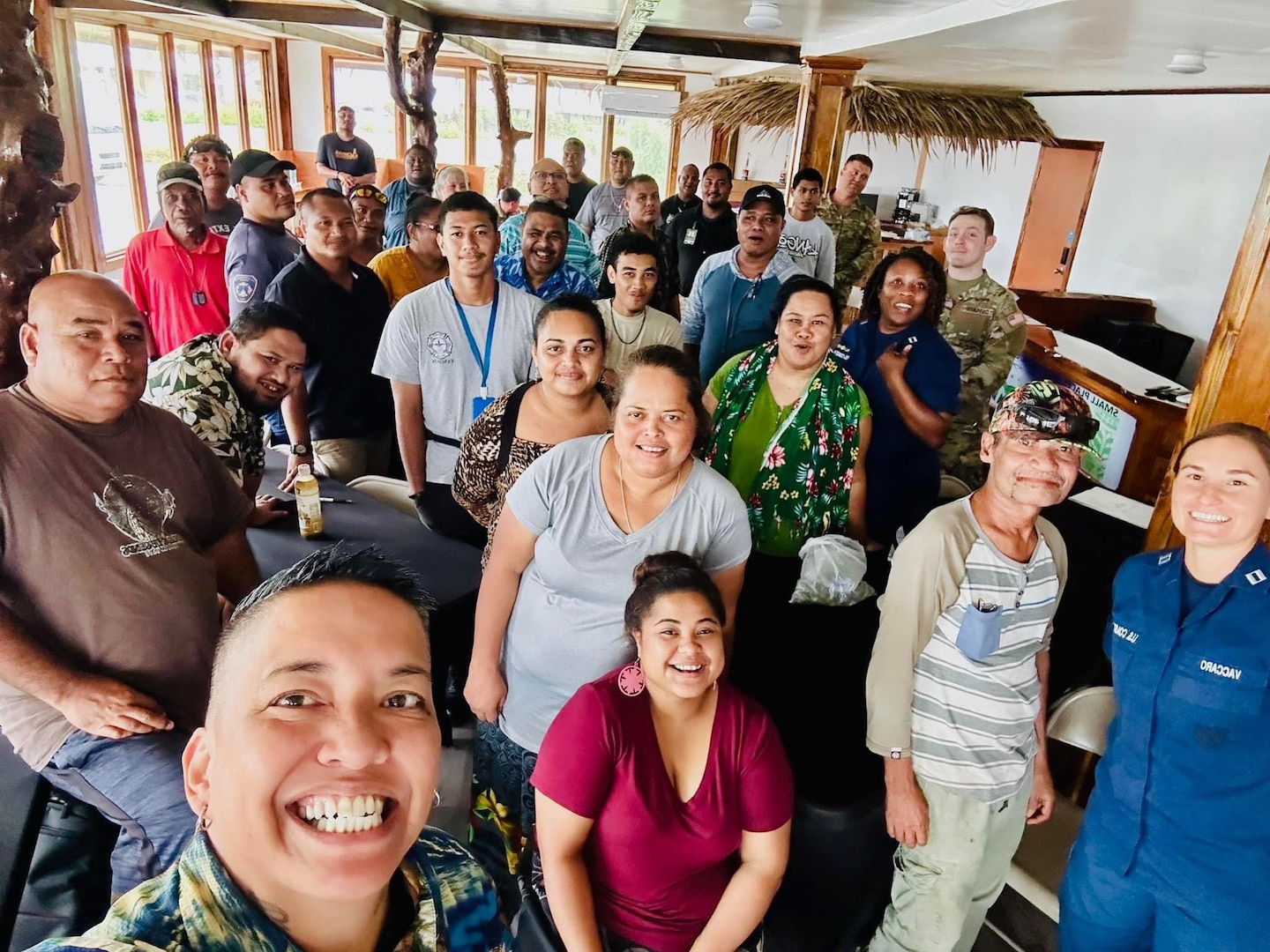 U.S. Coast Guard instructors, including Dee Cruz from the Emergency Management team, Lt. Kira Adams from the Joint Rescue Sub-Center in Guam, and Lt. Anna Maria Vaccaro, the Compact of Free Association (COFA) Liaison, take a photo with participants of the disaster preparedness and response workshop in Yap, Federated States of Micronesia, on Sept. 6, 2024. The effort focused on the activation, staffing, organization, deactivation, and demobilization of an Emergency Operations Center (EOC), offering Yapese partners crucial insights into managing disaster response. (U.S. Coast Guard photo by Dee Cruz)