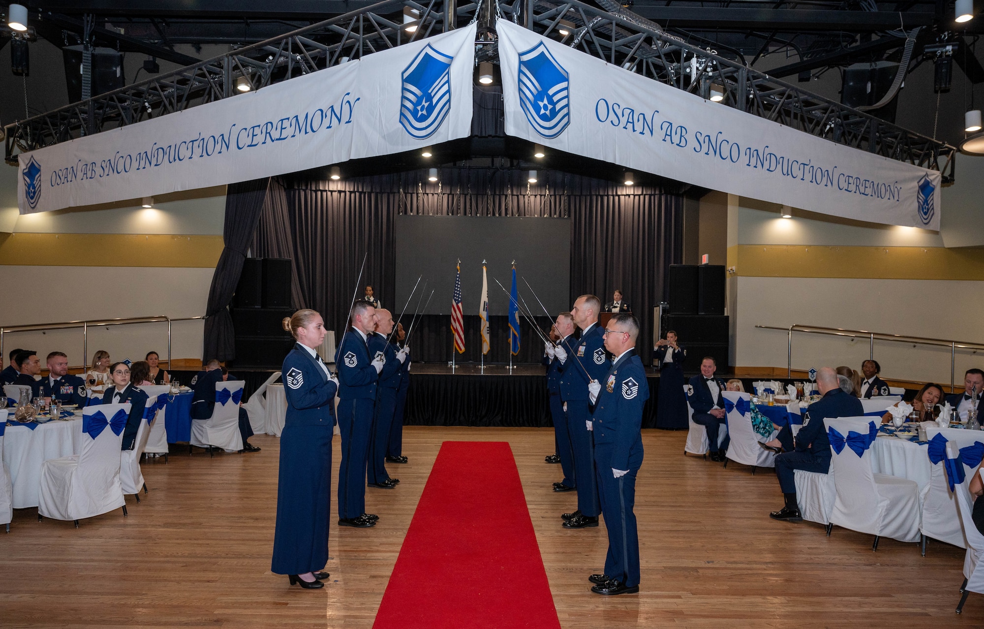 Osan’s First Sergeants Council form a sabre cordon during the Senior Non-Commissioned Officer Induction Ceremony at Osan Air Base, Republic of Korea, Sept. 6, 2024. Each inductee entered the room through a sabre cordon, which is used to congratulate the new SNCO’s and to show respect for the sacrifice and commitment they have taken to earn the rank of master sergeant. (U.S. Air Force photo by Staff Sgt. Christopher Tam)