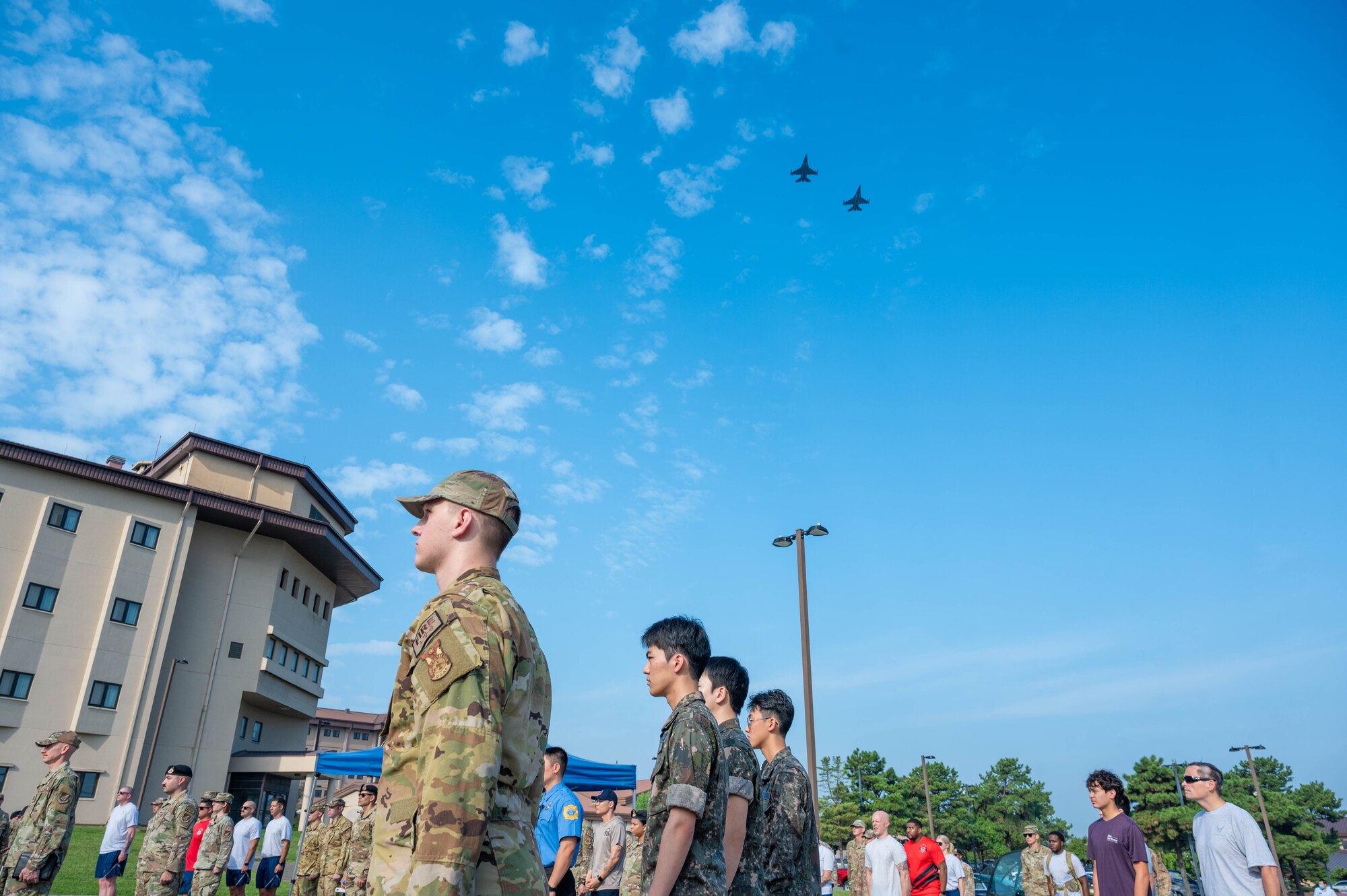 Two U.S. Air Force  F-16 Fighting Falcons assigned to the 36th Fighter Squadron perform a flyover during a 9/11 remembrance ceremony at Osan Air Base, Republic of Korea, Sept. 11, 2024. On Sept. 11, 2001, 2,977 people lost their lives due to the deadliest terrorist attack in history. A ceremony is usually held every year on Sept. 11 to honor and remember the lives that were lost. (U.S. Air Force photo by Staff Sgt. Christopher Tam)