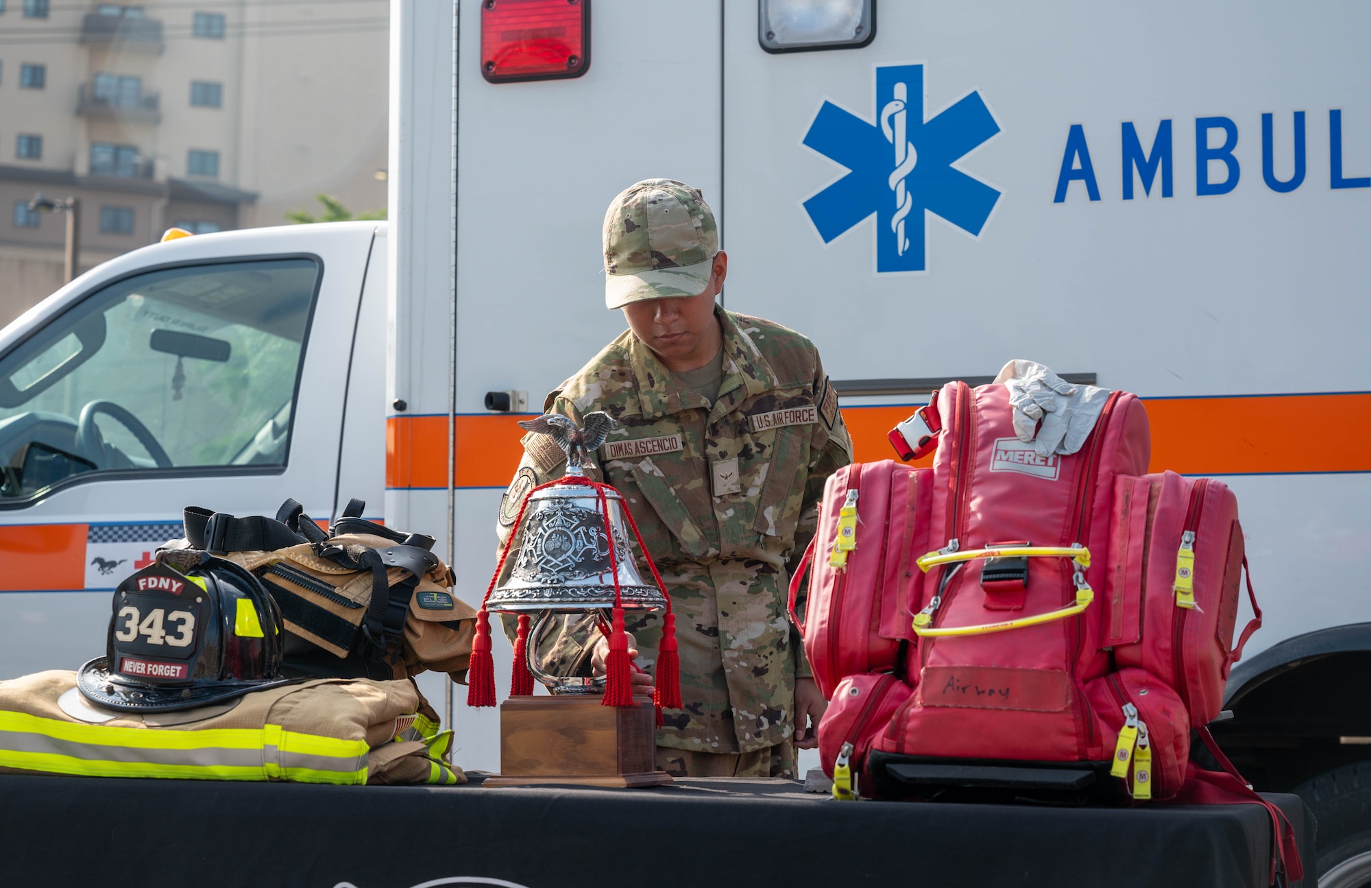U.S. Air Force Airman Erik Dimas Ascencio, 51st Civil Engineer Squadron firefighter, rings a bell during a 9/11 remembrance ceremony at Osan Air Base, Republic of Korea, Sept. 11, 2024. Ringing a bell on the 9/11 anniversary signifies a salute to fallen comrades. (U.S. Air Force photo by Staff Sgt. Christopher Tam)