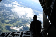 U.S. Air Force Senior Airman Tristan Desnerck, 1st Special Operations Squadron loadmaster, sits at the edge of a C-130 Hercules during Misawa Air Fest 2024 at Misawa Air Base, Japan, Sept. 8, 2024.