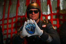 A U.S. Air Force Airman assigned to the Wings of Blue parachute team displays the team logo before jumping during Misawa Air Fest 2024 at Misawa Air Base, Japan, Sept. 8, 2024.