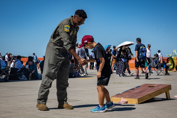 A U.S. Air Force member shakes hands with a Japanese boy during Misawa Air Fest at Misawa Air Base, Japan, Sept. 8, 2024.