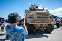 An Air Fest 2024 attendee photographs a Mine-Resistant Ambush Protected  vehicle during Air Fest 2024 at Misawa Air Base, Japan, Sept. 8, 2024.