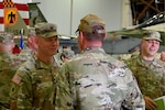U.S. Army Brig. Gen. Alan Gronewold, Oregon National Guard adjutant general, speaks with Tech. Sgt. Peter McNally, 173rd Logistics Readiness Squadron, after a mobilization ceremony at Kingsley Field in Klamath Falls, Oregon, Sept. 8, 2024.