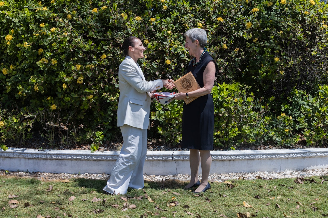 U.S. Marine Corps Lt. Col. Rebecca Bolz, left, the commanding officer of Combat Logistics Battalion 5 (Reinforced), Marine Rotational Force – Darwin 24.3, presents a gift to Donna Ann Welton, the U.S. Ambassador to Timor-Leste, after completion of a table top exercise, as part of a humanitarian assistance and disaster relief exercise at the U.S. Embassy Dili, Timor-Leste, Aug. 29, 2024. The table top exercise was conducted in coordination with the U.S. Embassy in Timor-Leste and the U.S. Agency for International Development, with a focus on projecting select role II medical, logistics, and Marine Air-Ground Task Force command and control capabilities off-continent. Bolz is a native of Wisconsin. (U.S. Marine Corps photo by Sgt. Cristian Bestul)