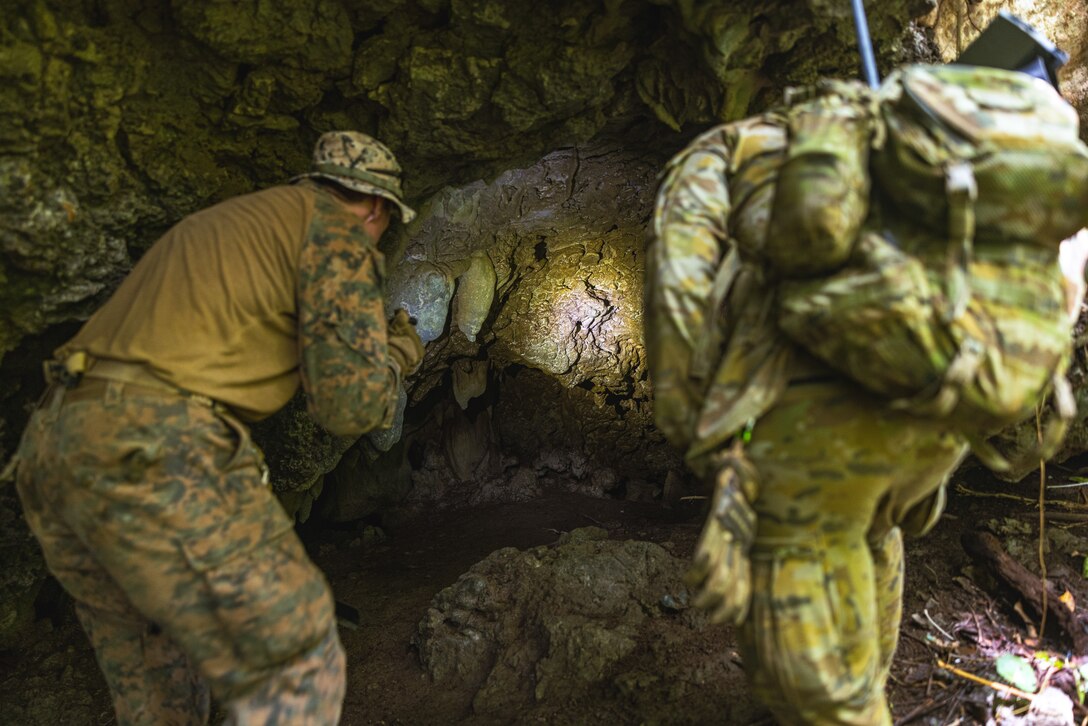 U.S. Marine Corps Sgt. William Barker, left, an explosive ordnance disposal technician with Combat Logistics Battalion 5 (Reinforced), Marine Rotational Force – Darwin 24.3, and Australian Army Sapper William Buckoke, a combat engineer with 6 Engineer Support Regiment, 20 Explosive Ordnance Disposal, check a cave for explosive remnants of war during Operation Render Safe 2024-2 at Munda, New Georgia, Solomon Islands, Sept. 8, 2024. Operation Render Safe 2024-2 is an Australian-led operation to exchange explosive ordnance tactics, techniques and procedures and reduce the risk of explosive remnants of war. From Aug. 30 to Sept. 13, the MRF-D 24.3 Marine Air-Ground Task Force deploys select explosive ordnance disposal teams, role 2 medical, Ospreys and force protection elements to the Solomon Islands for participation in Australian Defence Force’s execution of Operation Render Safe 2024-2 in order to enhance relationships with partner nations in the South Pacific. Barker is a native of Texas. (U.S. Marine Corps photo by Cpl. Juan Torres)