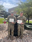 Staff Sgts. Ian Wilding, Delta Company 141st Brigade Support Battalion and Chris Yoder, Fox Company 181st Brigade Support Battalion, show off their awards following the 2024 National Guard Best Mechanic of the Year competition at Camp Williams, Utah, Aug. 25, 2024. Wilding took top honors; Yoder finished fourth out of 26 competitors.