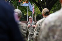 A U.S. Navy Sailor speaks to service members in formation.