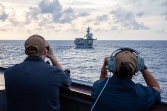 USS Russell (DDG 59) is underway with the Italian navy aircraft carrier ITS Cavour (CV 550)  in the South China Sea.