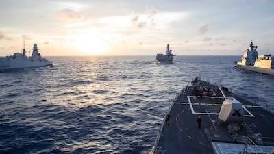 USS Russell (DDG 59) is underway with the Italian navy aircraft carrier ITS Cavour (CV 550) in the South China Sea.