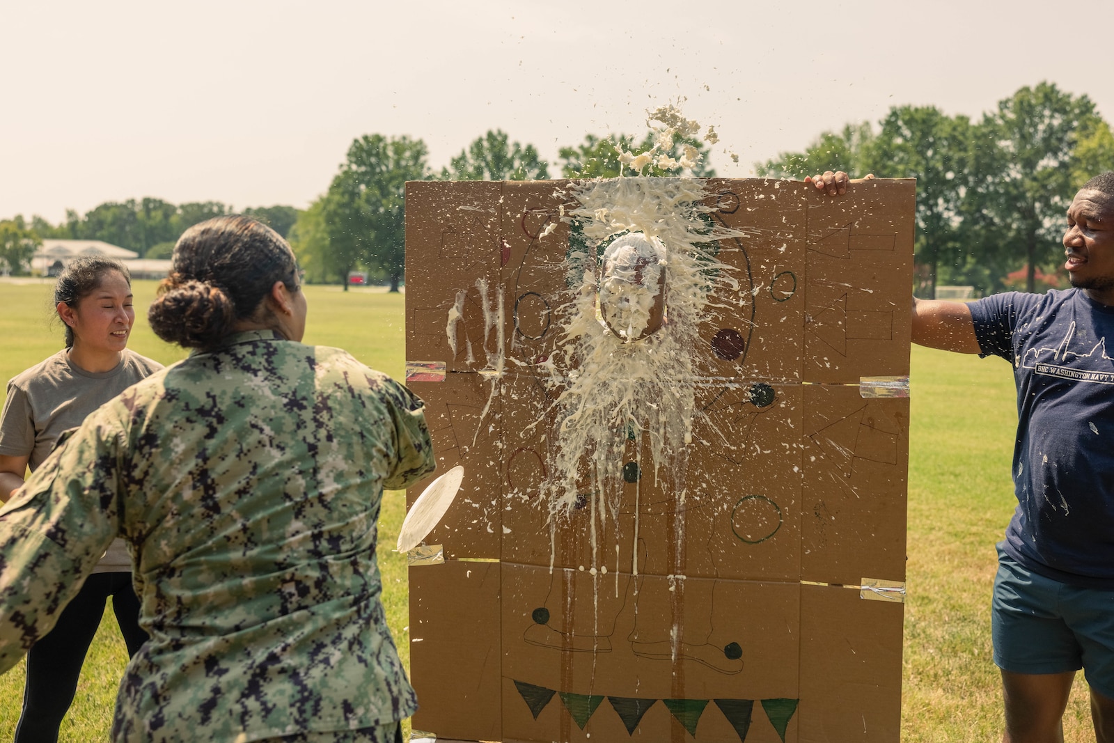 U.S. Navy Sailors with Navy Medicine Readiness and Training Command Quantico participate in a pie face event during a field meet at Lejeune Field on Marine Corps Base Quantico, Virginia, Aug. 29, 2024. The field meet took place to help build comradery and better the relations amongst the local Branch Health Clinics. (U.S. Marine Corps photo by Cpl. Darien Wright)