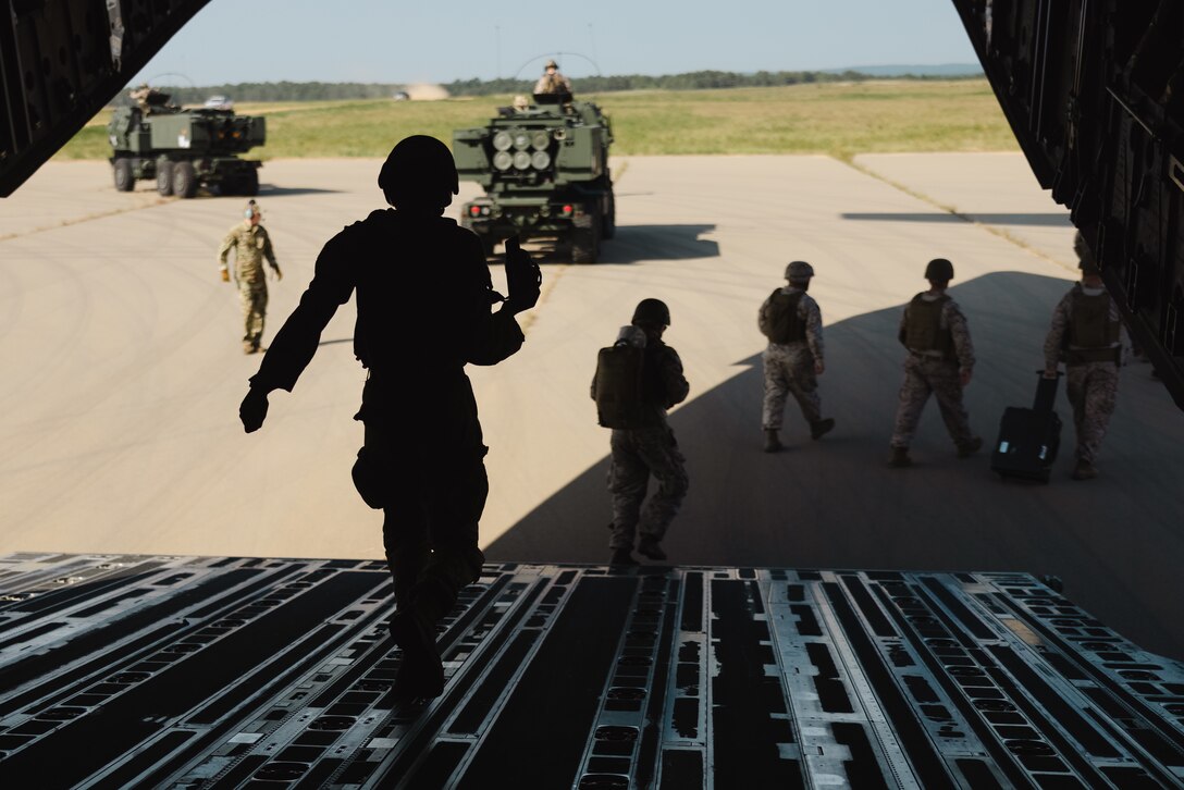 U.S. Marines with Hotel Battery, 2d Battalion, 10th Marine Regiment, 2d Marine Division disembark an Air Force C-17 Globemaster III assigned to the 156th Airlift Squadron on Fort Liberty, North Carolina, Aug. 29, 2024. Hotel Battery participated in a High Mobility Artillery Rocket System Rapid Infiltration training exercise to demonstrate the logistical capabilities associated with the rapid deployment of a HIMARS Rapid Insertion. (U.S. Marine Corps photo by Cpl. Antonino Mazzamuto)
