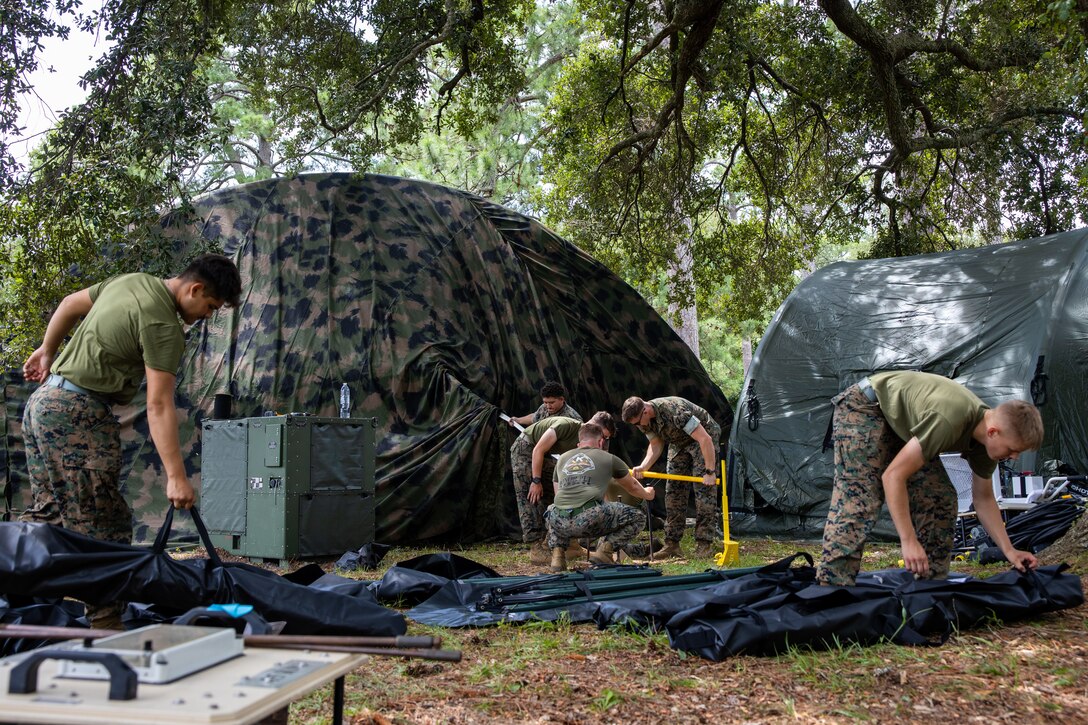 U.S. Marines with II Marine Expeditionary Force Support Battalion, II MEF Information Group, help establish a joint logistics operating center while preparing for MEF Exercise 24 at Marine Corps Base Camp Lejeune, North Carolina, Aug. 22, 2024. MEFEX-24 is an exercise that develops command and control capabilities and warfighting functions of the MEF staff as an operational command in preparation for crisis across the spectrum of conflict. (U.S. Marine Corps photo by Lance Cpl. Jack Labrador)