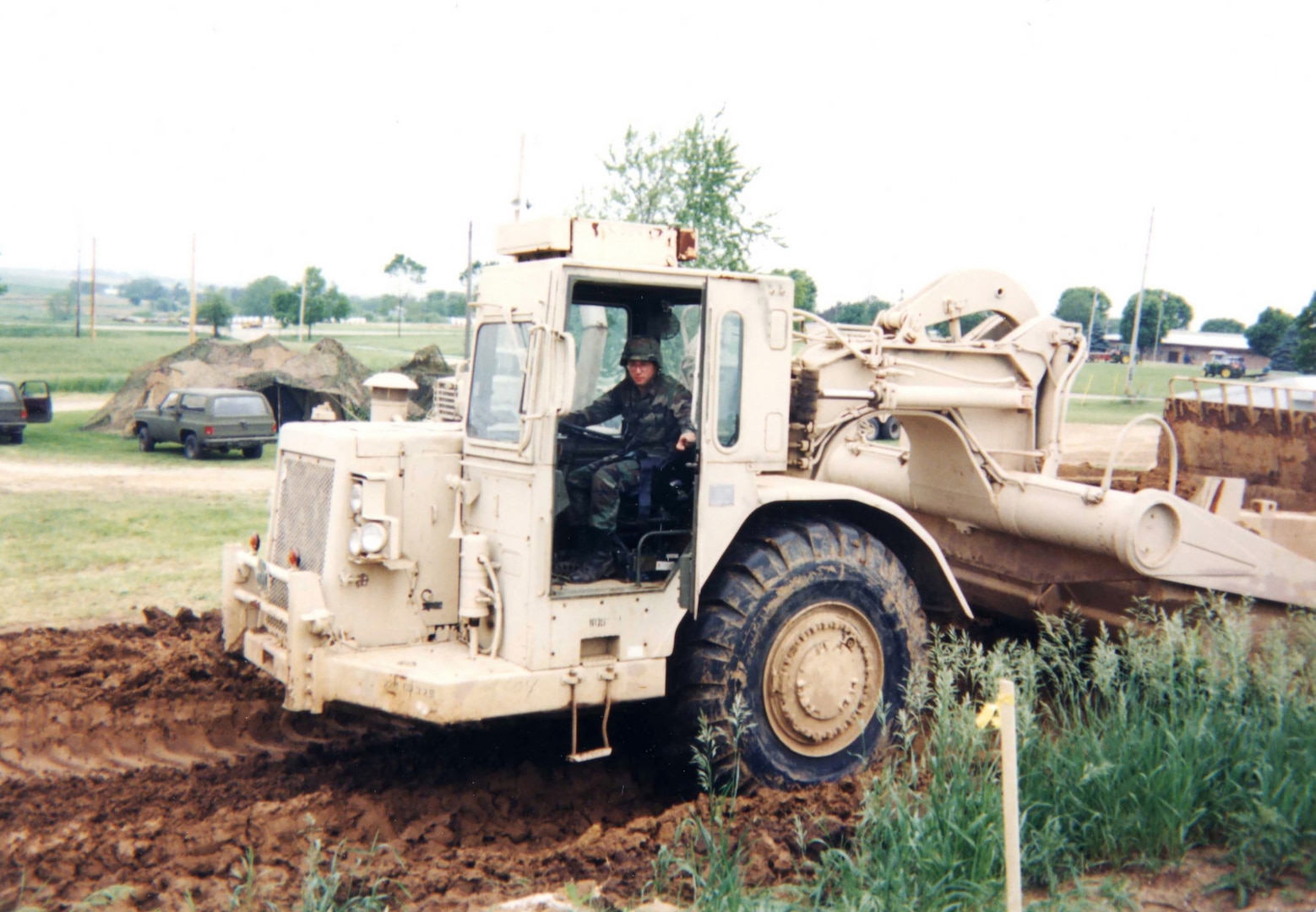 A member of the Wisconsin Army National Guard’s 229th Engineer Company in Platteville, Wis., operates heavy equipment on the site of a local training area in 1995. Unit members would set up tents and field headquarters on site and treat the project area as a deployed mission site to conduct other Soldier readiness training. The 229th was involved in numerous projects today referred to as innovative readiness training, such as athletic fields, campsites and parking pads for military fuel tankers. Photo courtesy of Jeff Breuer