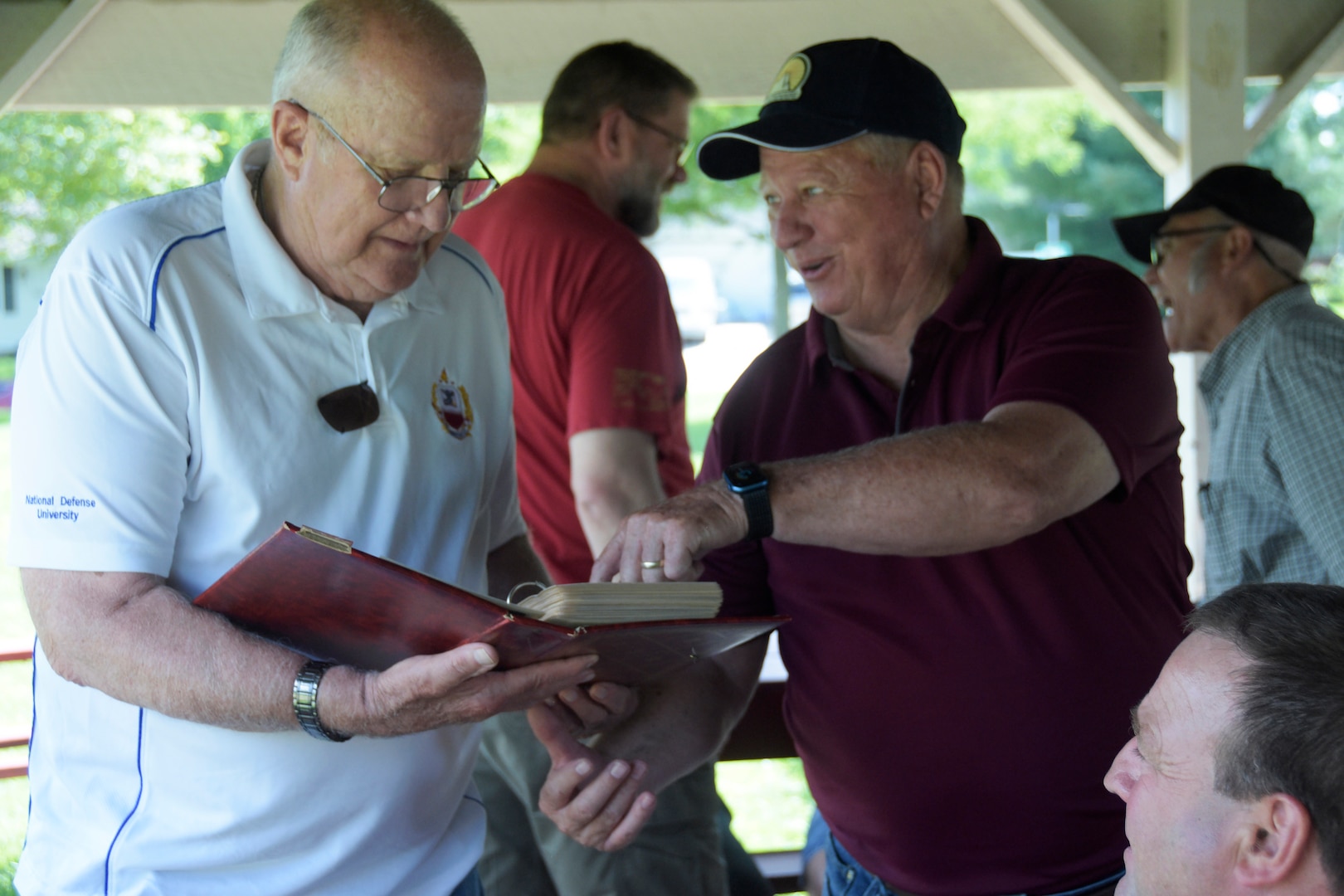 Paul Budden, right, a former first sergeant for the Wisconsin Army National Guard’s 229th Engineer Company in Platteville, Wis., shares his thoughts about Gerald Zuhlsfdorf’s photo album during a unit reunion Aug. 1. Zuhlsdorf, left, also served as the unit first sergeant before becoming the command sergeant major for the Wisconsin Military Academy. The unit was involved in numerous local training areas — projects today referred to as innovative readiness training — such as athletic fields, campsites and parking pads for military fuel tankers. Wisconsin Department of Military Affairs photo by Vaughn R. Larson