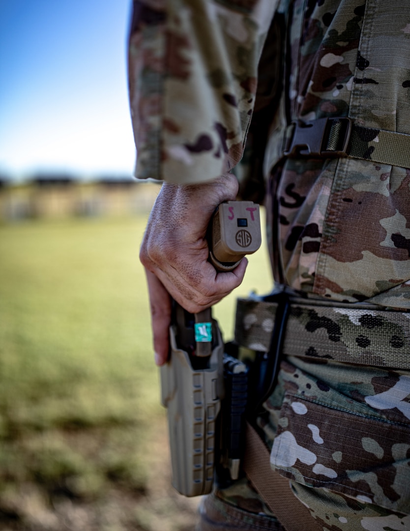 Maj. Justin Potts, an officer assigned to Camp Gruber Training Center Range Control, Oklahoma National Guard, draws his M17 pistol during the 2024 Governor's 20 Marksmanship Competition, Sept. 8, 2024 at Camp Gruber Training Center, Oklahoma. The Oklahoma National Guard Governor’s 20 is an annual competition where Oklahoma Army and Air National Guardsmen compete in a series of shooting events to showcase the Oklahoma National Guard’s top marksmen. (Oklahoma National Guard photo by Sgt. Haden Tolbert)