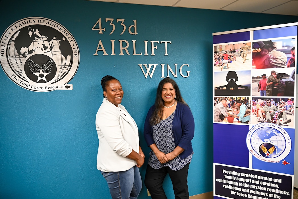 Leticia Gonzalez, 433rd Airlift Wing Military and Family Readiness program manager, poses alongside Nakia Evans, Magellan Federal personal financial counselor, for a photo to showcase the Military and Family Readiness and their programs in their conference room.