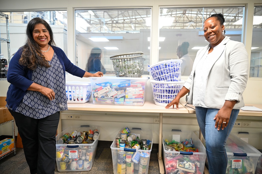 Leticia Gonzalez, 433rd Airlift Wing Military and Family Readiness program manager, poses alongside Nakia Evans, Magellan Federal personal financial counselor, for a photo to showcase the Military and Family Readiness food pantry program.