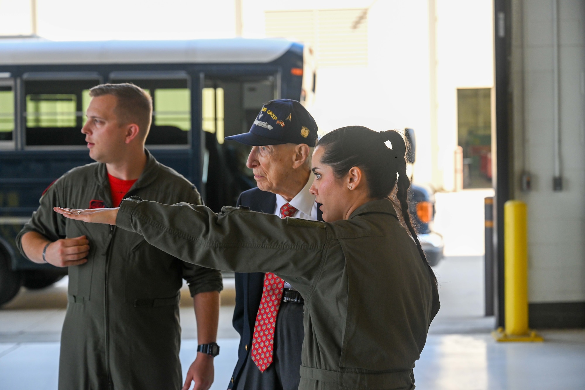 Senior Airman Stephanie Peraza, 350th Air Refueling Squadron boom operator, shows retired Maj. John “Lucky” Luckadoo around a hangar before taking a tour of a KC-135 Stratotanker Sept. 6, 2024, at McConnell Air Force Base, Kansas. Luckadoo was stationed at McConnell during World War II in the 350th Bomb Squadron. The visit reminded future generations of the sacrifices made by his generation. (U.S. Air Force photo by Senior Airman William Lunn)
