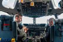 A Pilot sits in the flight deck with the Honorable Ashish Vazirani