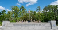 Service members stand for a photo