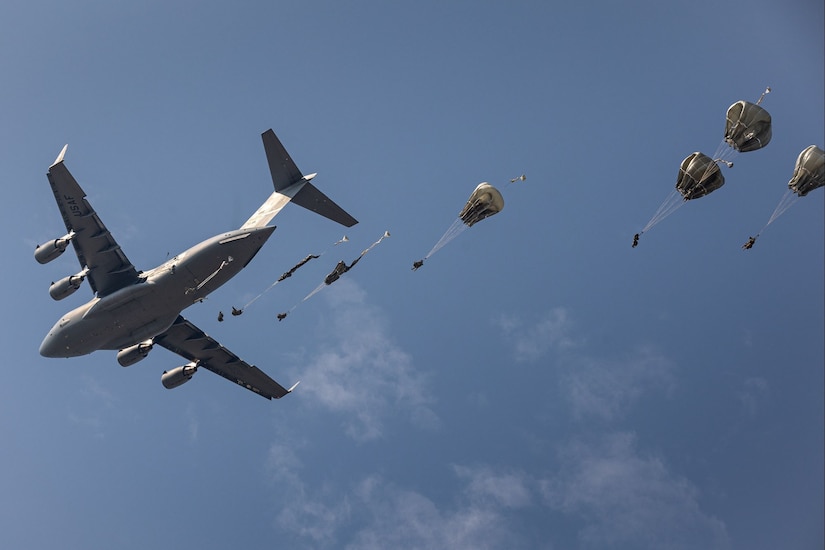 Soldiers jump from an Air Force C-17 Globemaster III aircraft.