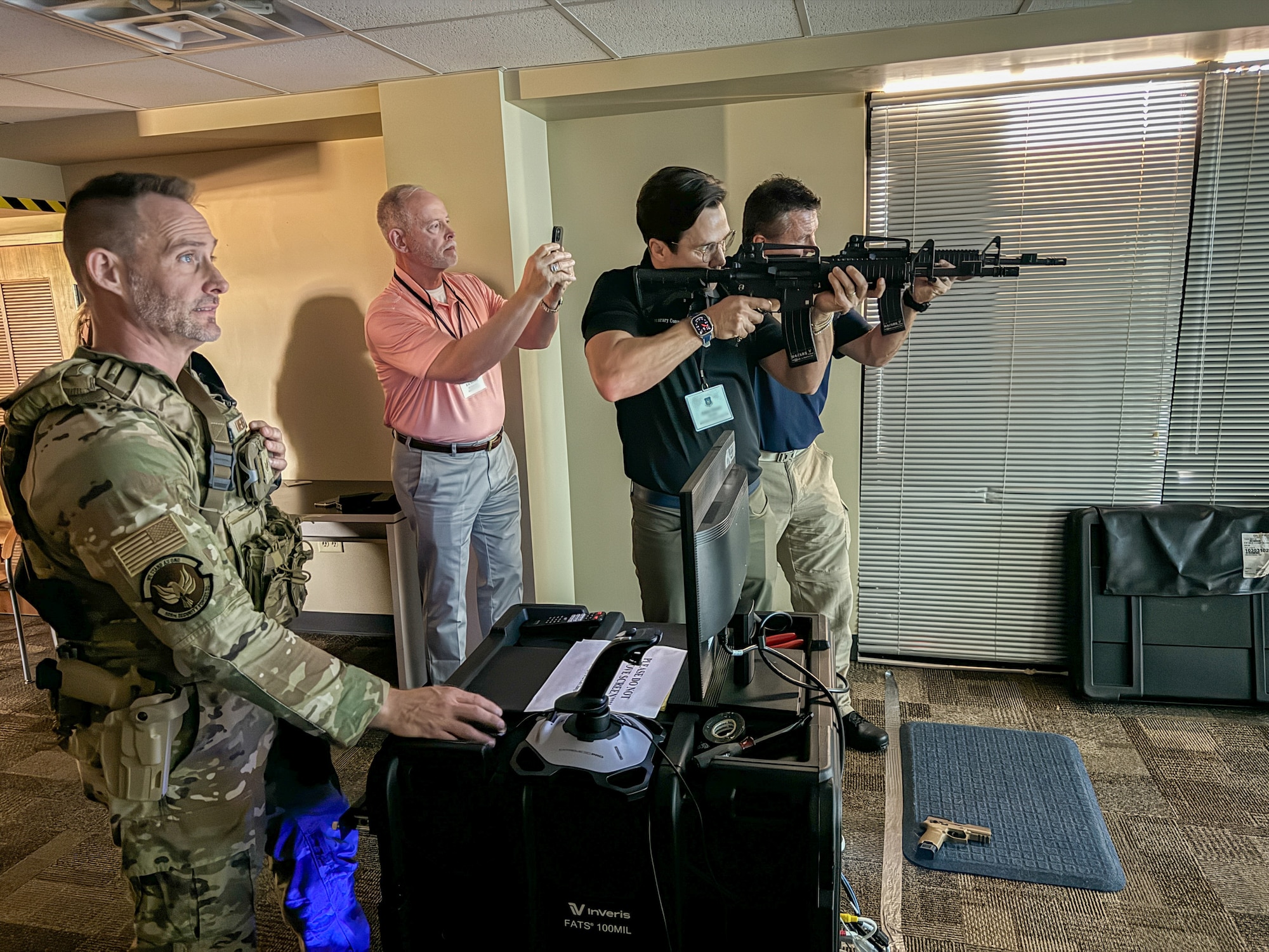 U.S. Air Force Reserve Command (AFRC) civic leaders fire M4A1 carbine rifles during a demonstration of the InVeris Firearms Training System while touring the 926th Wing, 926th Security Forces Squadron, Nellis Air Force Base, Nevada, Sept. 5, 2024. Lt. Gen. John Healy, commander of the AFRC and chief of the Air Force Reserve (AFR), hosted a two-day civic leader tour to Nellis Air Force Base, Nevada and March Air Reserve Base, California to provide familiarization and education about the AFR mission and help the civic leaders from across the nation get an up-close and personal view of some of the transformative initiatives happening within the command. (U.S. Air Force photo by Roger Parsons)