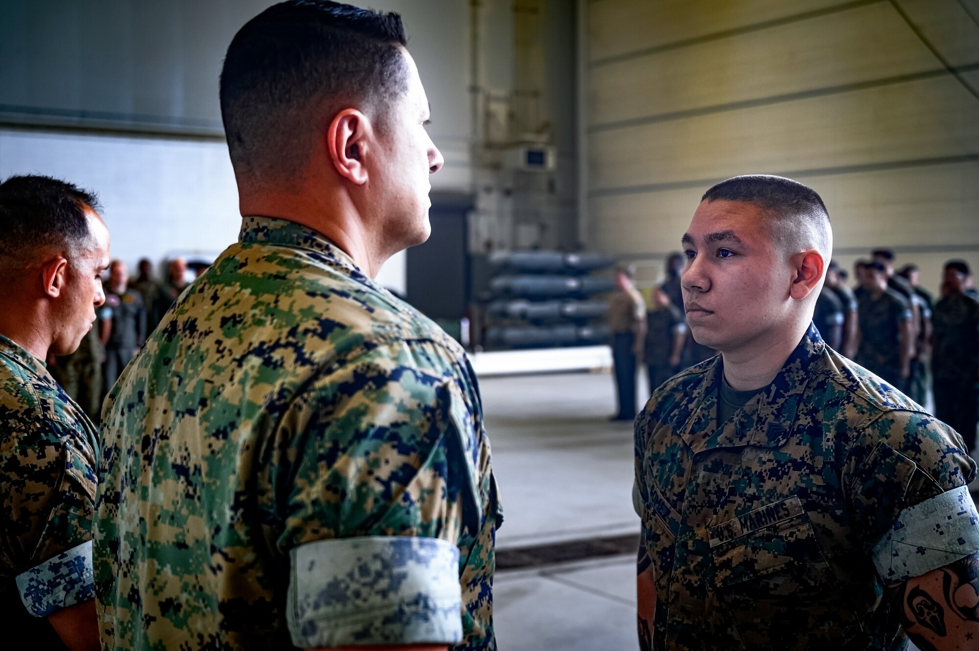 U.S. Marine Corps Col. Pablo Torres, Marine Aircraft Group 49 commanding officer, and Sgt. Andrew Gomez, MAG 49 aviation supply specialist, stand at attention during an award ceremony at Joint Base McGuire-Dix-Lakehurst, N.J., Aug. 14, 2024. Gomez received the Navy and Marine Corps Medal for extricating a passenger from a burning vehicle on June 19, 2023. (U.S. Air Force photo by Senior Airman Matt Porter)