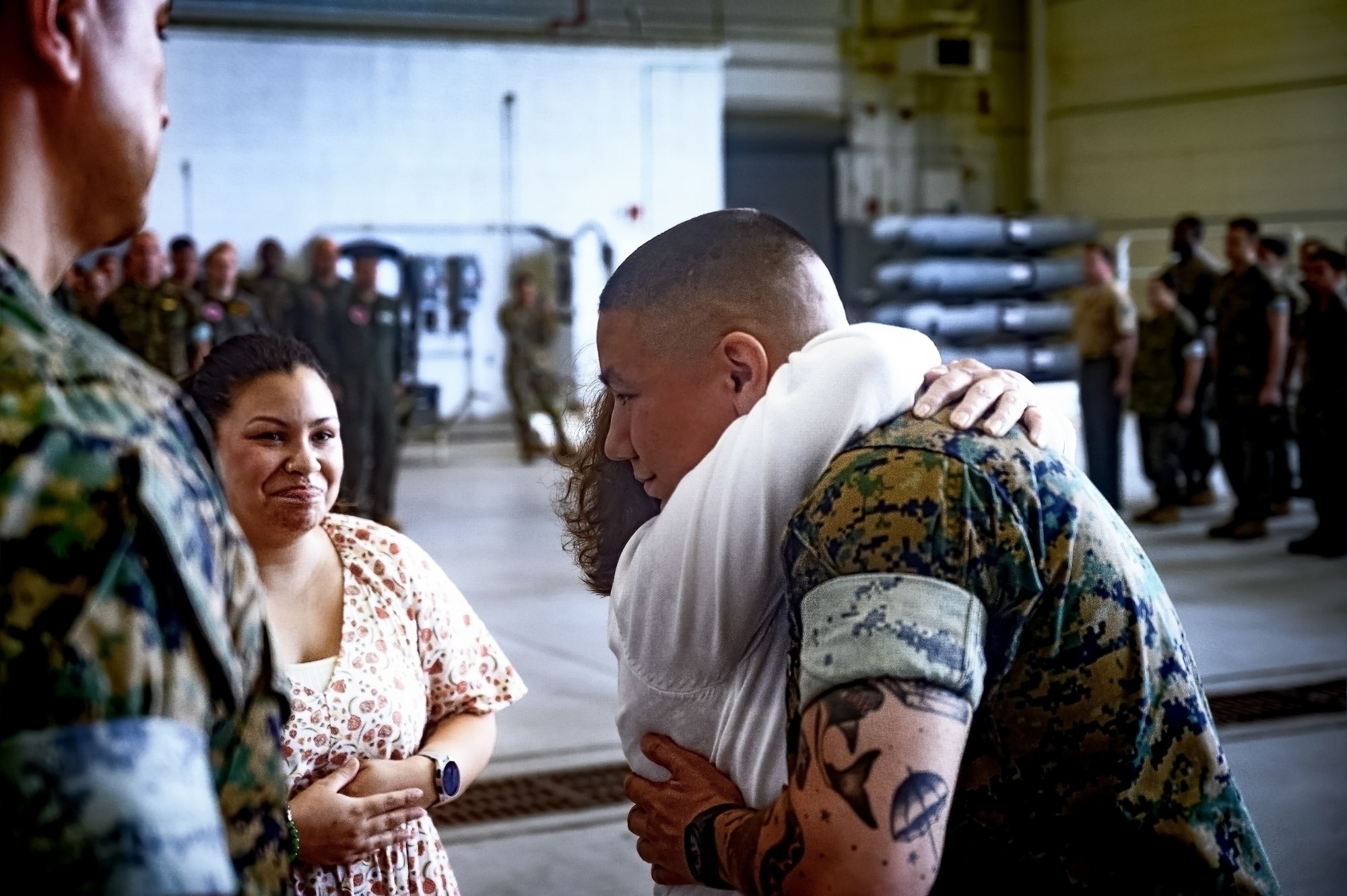 U.S. Marine Corps Sgt. Andrew Gomez, Marine Aircraft Group 49 aviation supply specialist, embraces his mother during an award ceremony at Joint Base McGuire-Dix-Lakehurst, N.J., Aug. 14, 2024. Gomez received the Navy and Marine Corps Medal for extricating a passenger from a burning vehicle on June 19, 2023. (U.S. Air Force photo by Senior Airman Matt Porter)
