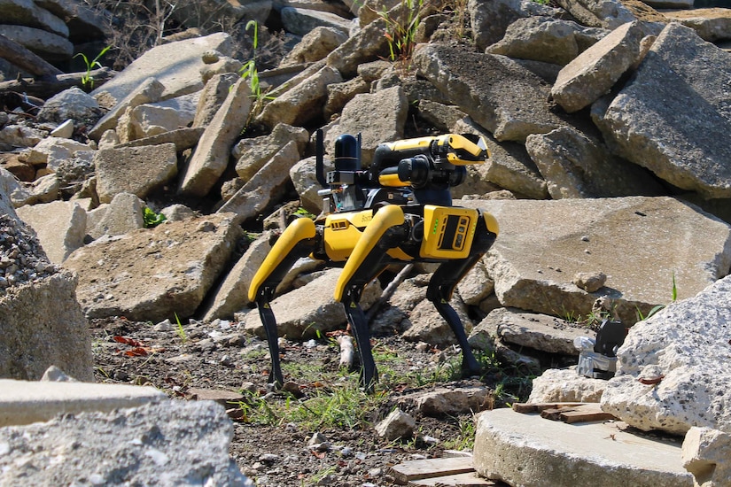 A robot dog navigates through a rubble pile.