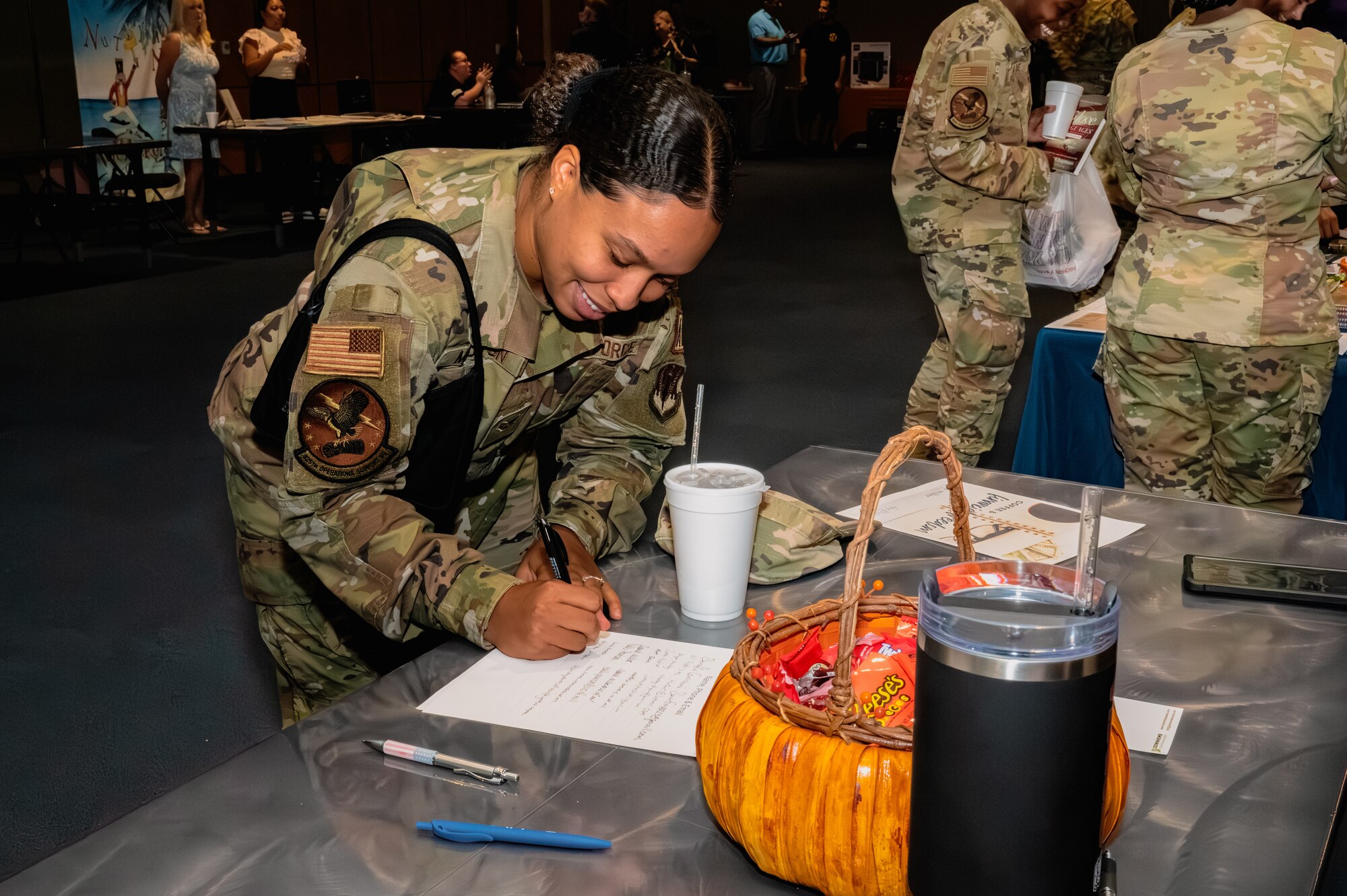 A U.S. Airman signs up for a club during the Tyndall Connects expo