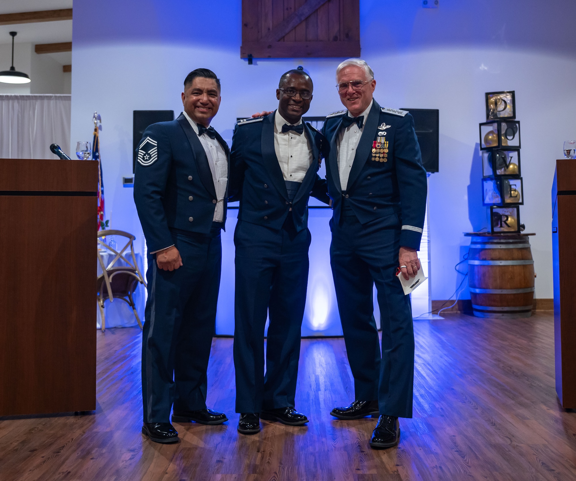 U.S. Air Force Senior Master Sgt. Michael Garza, left, 436th Airlift Wing public affairs superintendent, Capt. Charles Essel, center, 436th Medical Group TRICARE operations and patients administration flight commander, and retired Lt. Gen. William Welser III, right, poses for a photo during the 77th Anniversary Air Force Ball ceremony at King Cole Farms in Dover, Delaware, Sept. 7, 2024. Dover Air Force Base celebrated the anniversary with a red carpet-themed event. (U.S. Air Force photo by Senior Airman Amanda Jett)