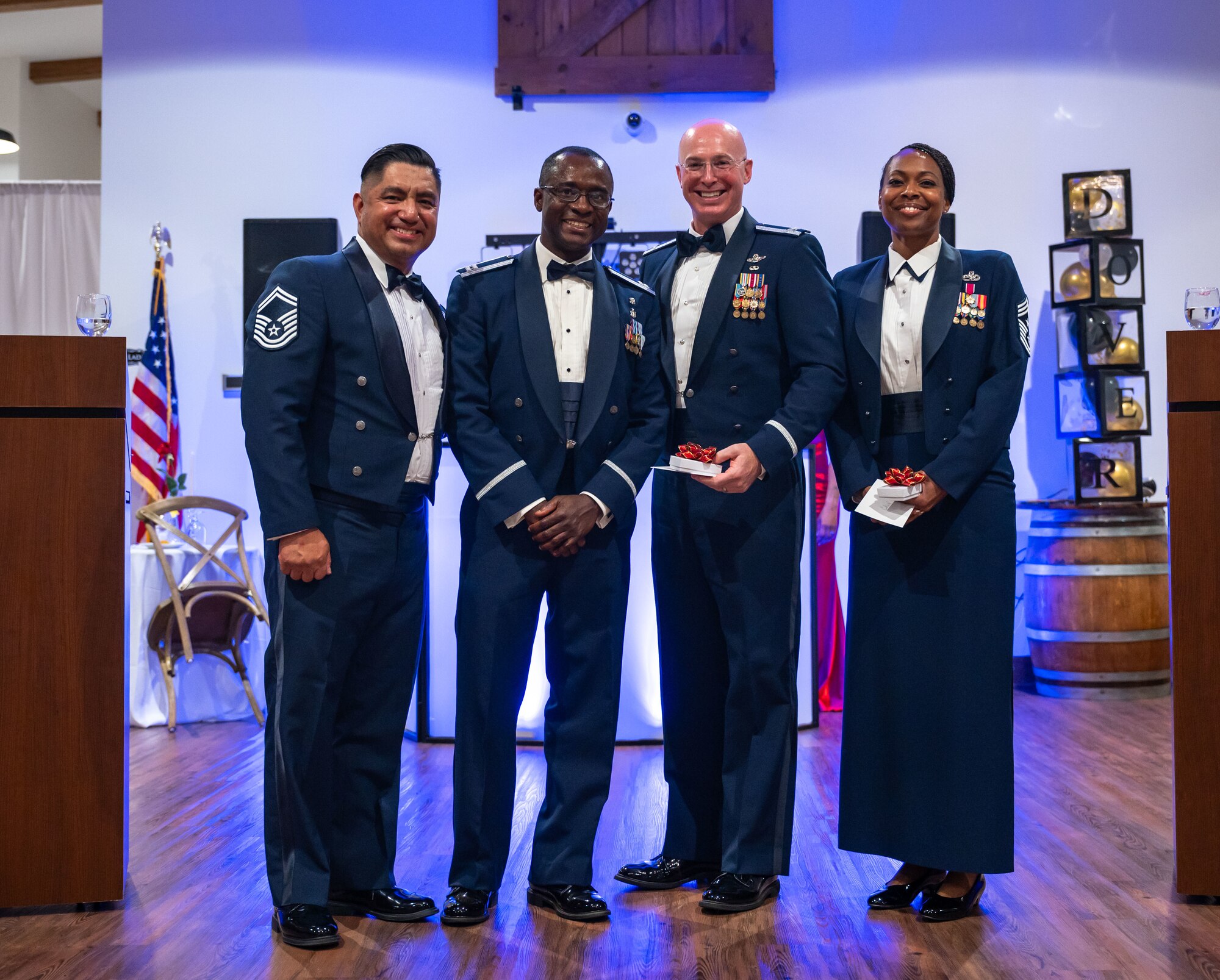 From the left, U.S. Air Force Senior Master Sgt. Michael Garza, 436th Airlift Wing public affairs superintendent, Capt. Charles Essel, 436th Medical Group TRICARE operations and patients administration flight commander, Col. Chris McDonald, 436th AW commander, and Chief Master Sgt. Carolyn Russell, 436th AW command chief, poses for a photo during the 77th Air Force Ball ceremony at King Cole Farms in Dover, Delaware, Sept. 7, 2024. Dover Air Force Base celebrated the anniversary with a red carpet-themed event. (U.S. Air Force photo by Senior Airman Amanda Jett)