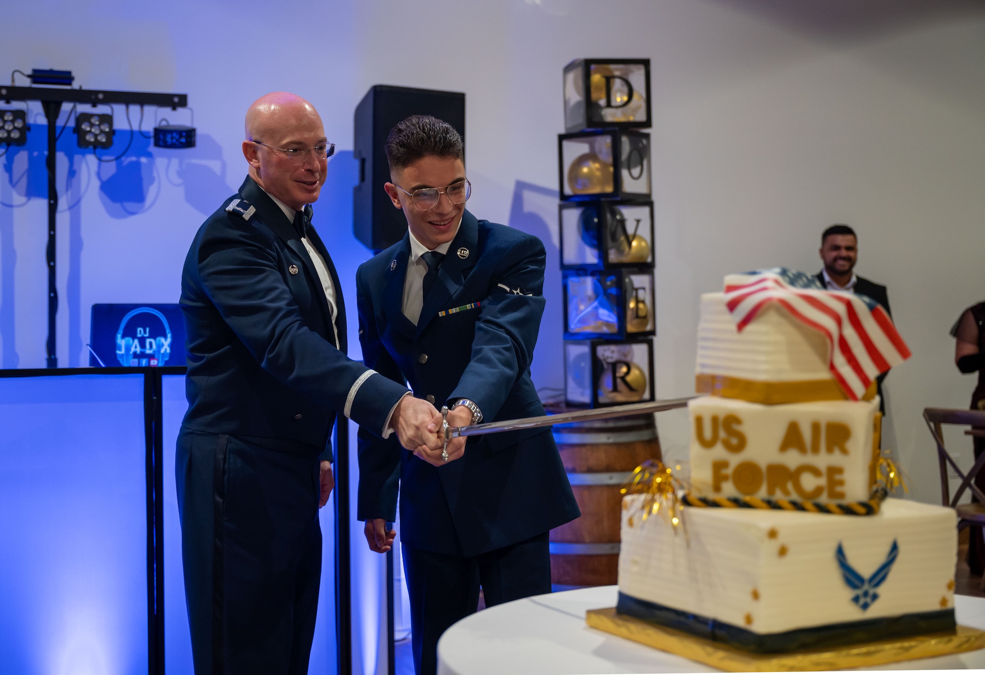 U.S. Air Force Col. Chris McDonald, left, 436th Airlift Wing commander, and Airman Roberto Cabrera Delgado, 436th Operational Support Squadron air traffic controller journeyman, cut the cake at the 77th Anniversary Air Force Ball at King Cole Farms in Dover, Delaware, Sept. 7, 2024. It is Air Force tradition to give the first slice of cake to the most junior Airman among attendees. (U.S. Air Force photo by Senior Airman Amanda Jett)