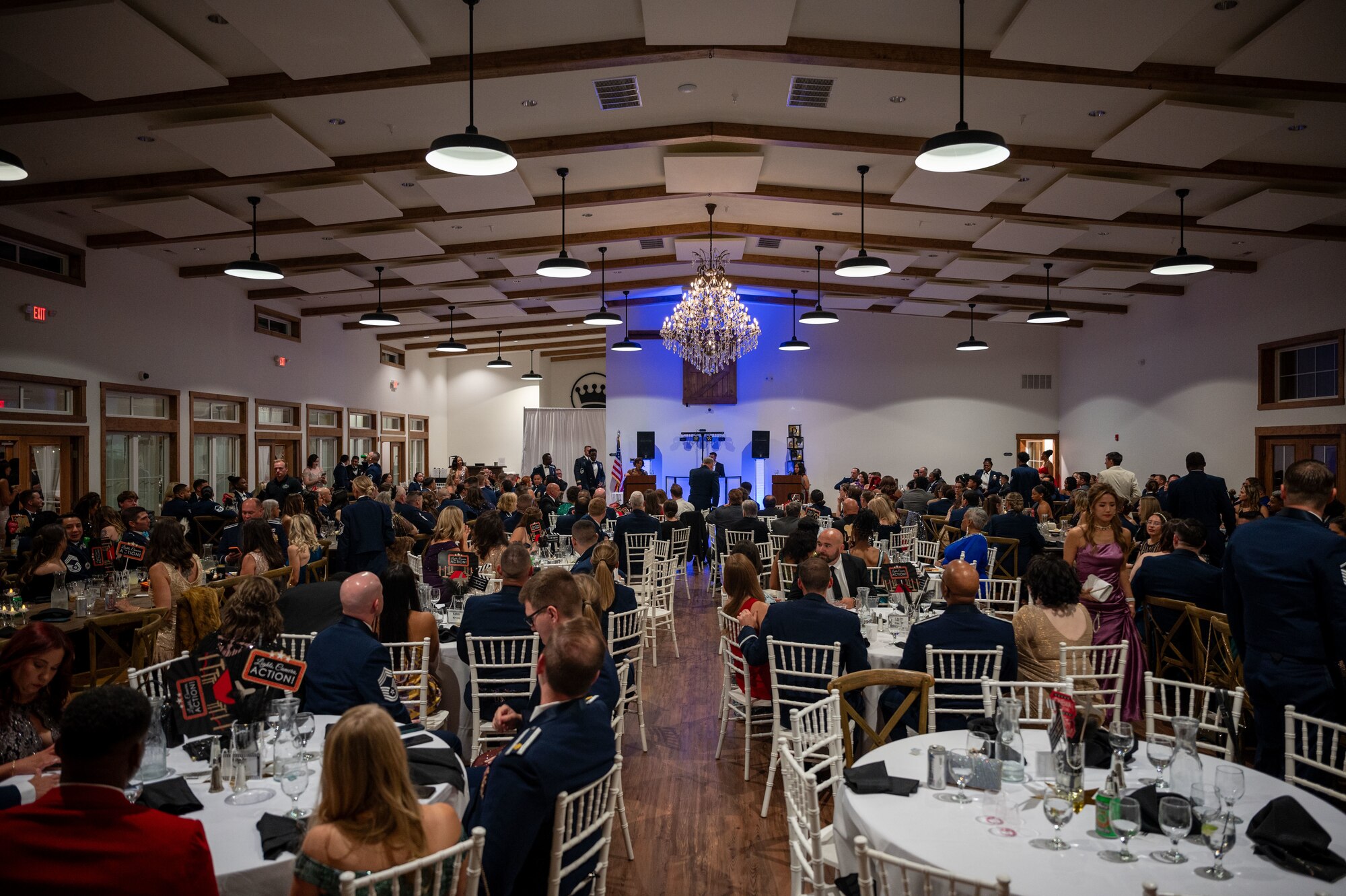 Team Dover members take their seats before the opening remarks are given in recognition of the 77th Anniversary Air Force Ball at King Cole Farms in Dover, Delaware, Sept. 7, 2024. Dover Air Force Base celebrated the anniversary with a red carpet-themed event. (U.S. Air Force photo by Senior Airman Amanda Jett)