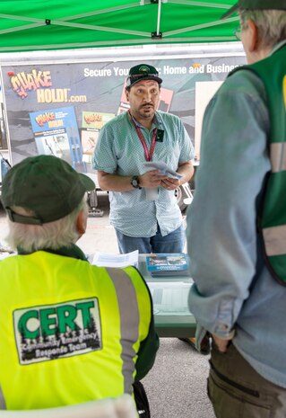 Roberto Levy, reactor servicing branch head, Code 105.3, Radiological Monitoring, gathers information from the Kitsap County Department of Emergency Management officials Sept. 3, 2024, during the emergency Preparedness Fair at Puget Sound Naval Shipyard & Intermediate Maintenance Facility in Bremerton, Washington.  (U.S. Navy photo by Wendy Hallmark)