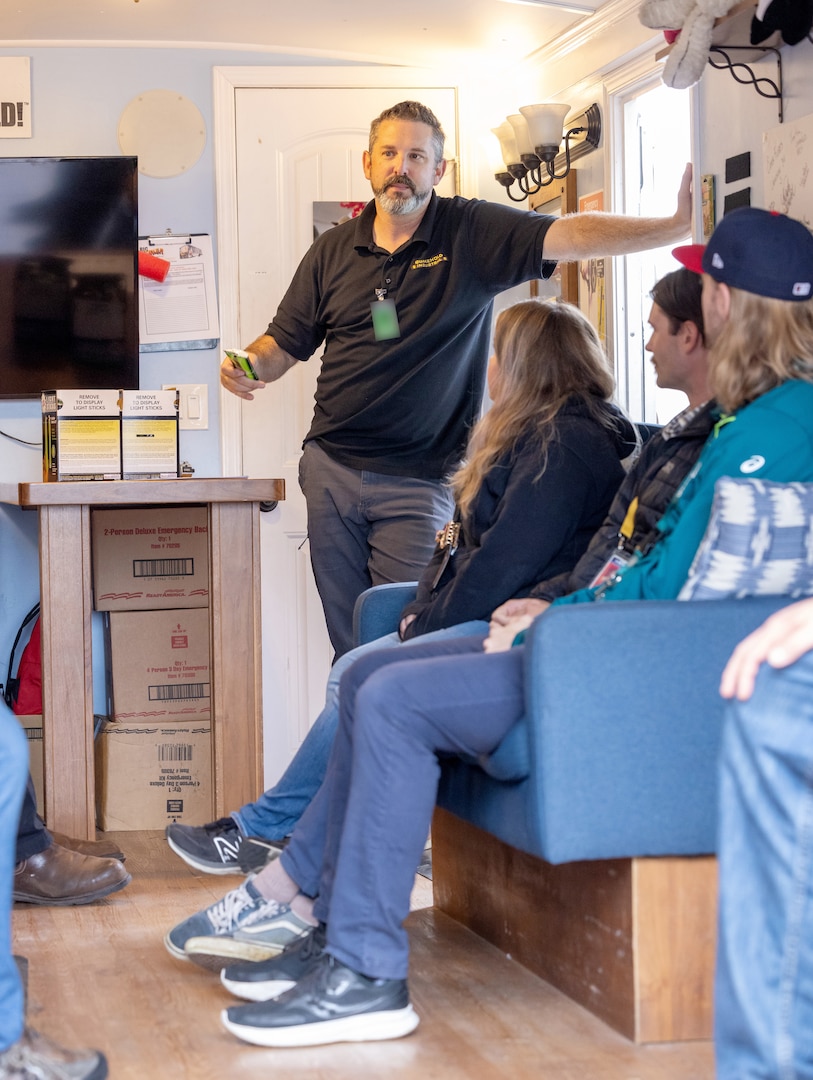 Tom Woertz, a representative from Big Shaker Enterprises, LLC., describes the effects of an earthquake with employees before engaging a mobile earthquake simulator Sept. 3, 2024, during an emergency Preparedness Fair outside Building 1106 at Puget Sound Naval Shipyard & Intermediate Maintenance Facility in Bremerton, Washington.  (U.S. Navy photo by Wendy Hallmark)