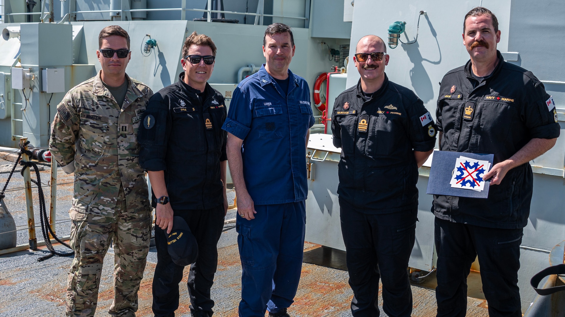 U.S. Coast Guard Capt. Timothy Lavier and Lt. Jared F. Mihalcik meet with the command of the HMCS Yellowknife, while moored in San Diego, Sept. 12, 2024.  The Royal Canadian Navy worked on patrol with a Coast Guard Law Enforcement Detachment to support the counter-narcotics mission. (U.S. Coast Guard photo by Petty Officer 3rd Class Richard Uranga/Released)