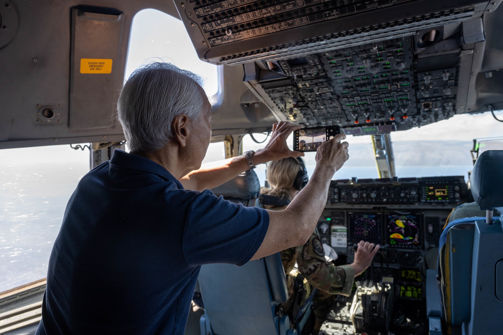 A civilian photographs the sky during a flight on a military aircraft.