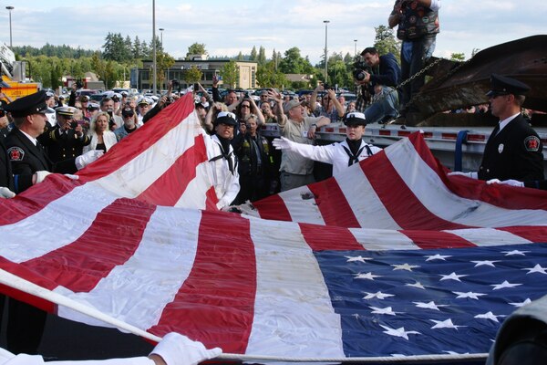 Parading a Tradition…There has been a color guard legacy from Sailors assigned to Naval Hospital Bremerton over the years, rendering support for a wide range of official observances, both on and off Navy installations. From Washington State Special Olympic events to Memorial Day remembrances to even unique iconic requests to conduct symbolic and solemn flag presentation and folding for two steel I-beams from the World Trade Center attack on Sept. 11, 2001, which were transported to Kitsap County in 2010 to become the focal point of a 9/11 memorial (Official Navy photo by Douglas H Stutz, NHB/NMRTC Bremerton public affairs officer).