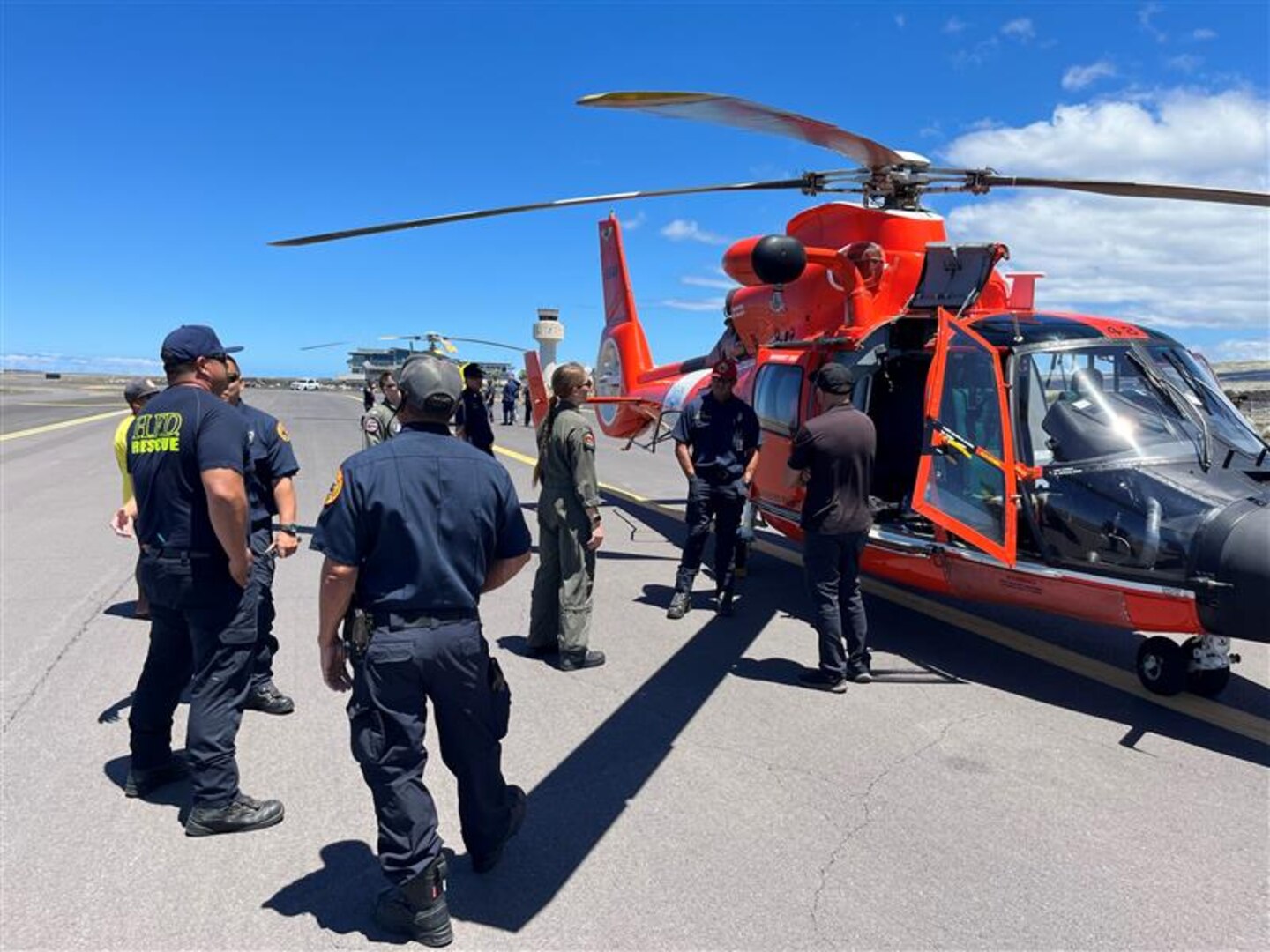 A group gathers in front of a MH-65 Dolphin helicopter at a static display in Kawaihae, Hawai'i, Sep. 12, 2024.