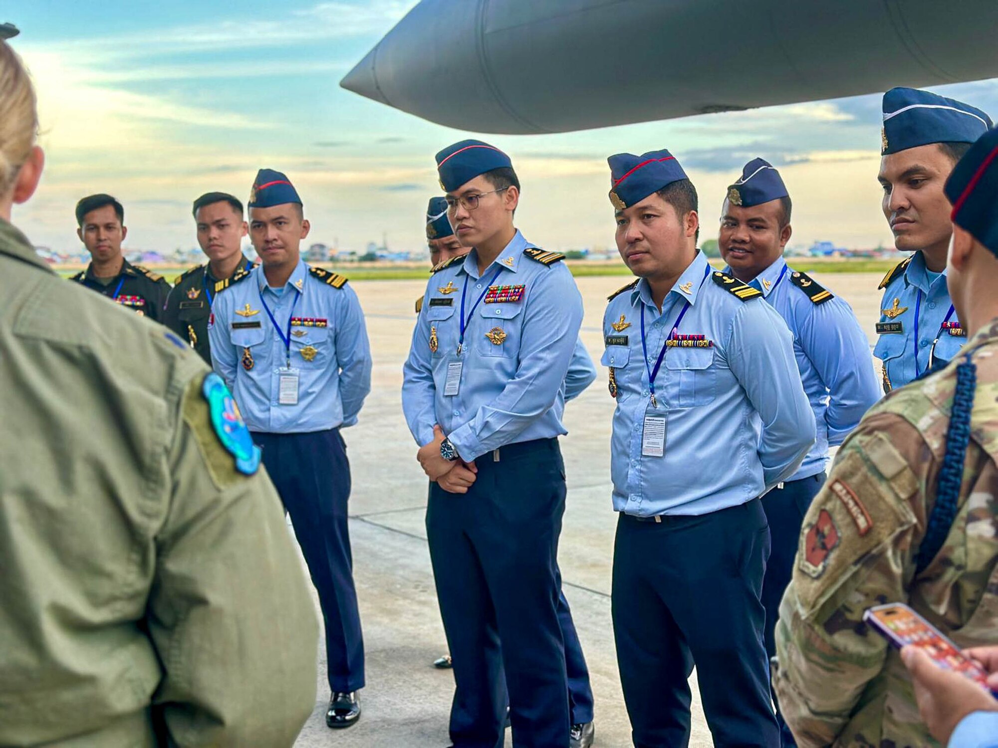 Royal Cambodian Air Force officers listen to Montana Air National Guard Airmen explain the mission of the joint exercise, Atlas Angel, while the unit’s C-130J Hercules refuels at the Phnom Penh International Airport in Phnom Penh, Cambodia.