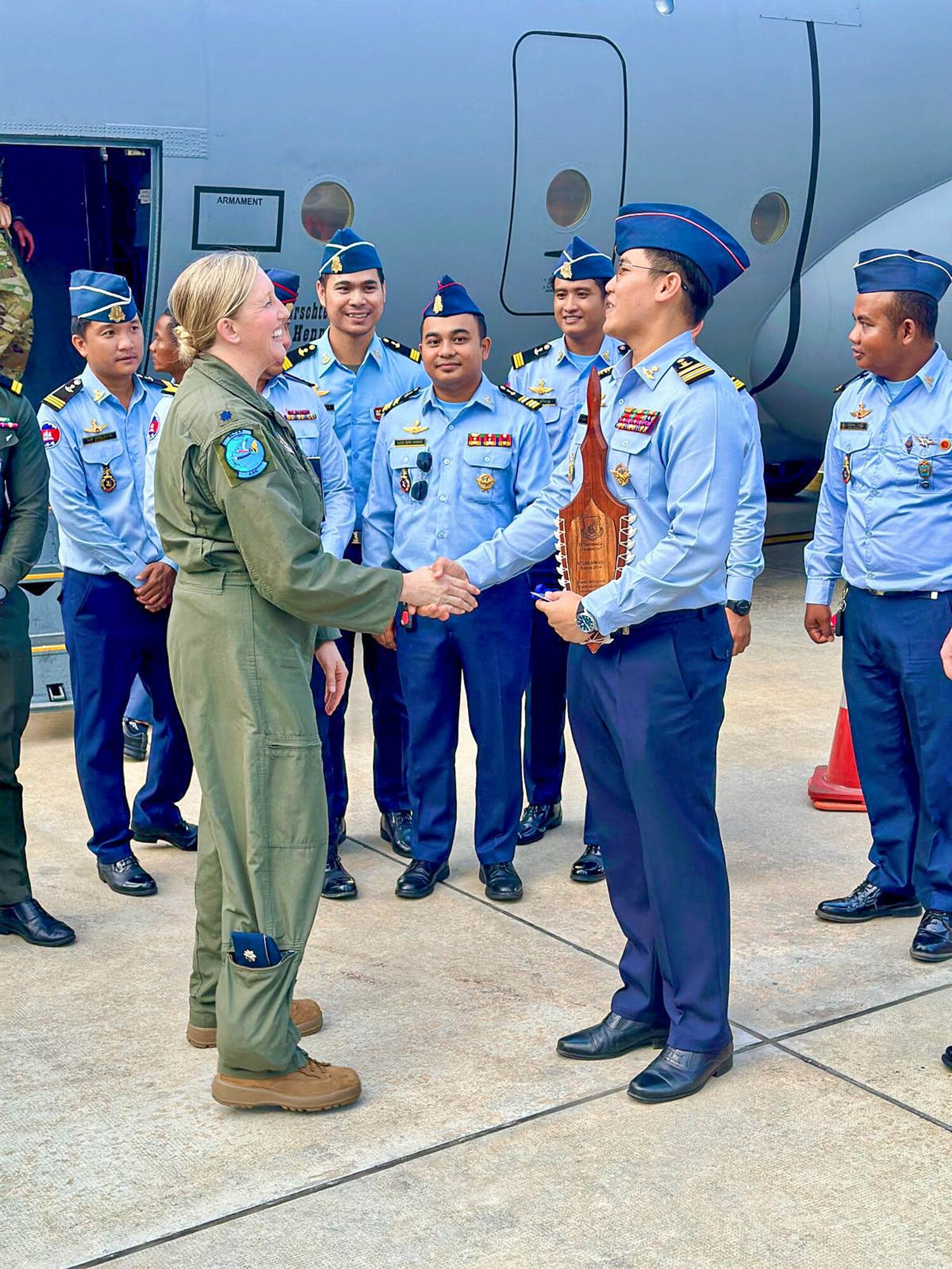 An Airman from the Montana Air National Guard interacts with a Royal Cambodian Air Force officer while the unit’s C-130J Hercules refuels at the Phnom Penh International Airport for the joint military exercise Atlas-Angel in Phnom Penh, Cambodia.